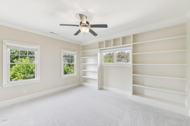528 Bankhead Dr, Cary, NC 27519 - empty room featuring carpet flooring, ceiling fan, crown molding, and built in shelves