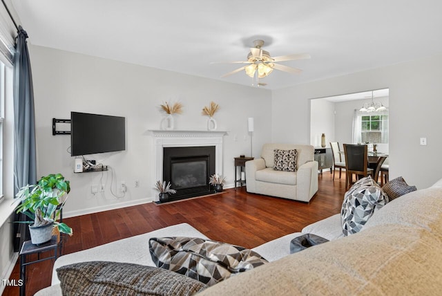 5 Ocean Ct, Durham, NC 27704 - living area featuring wood finished floors, ceiling fan, a fireplace with flush hearth, and a chandelier