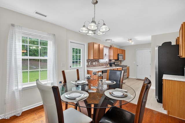 5 Ocean Ct, Durham, NC 27704 - dining space with a chandelier, plenty of natural light, and light wood-type flooring