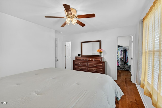 5 Ocean Ct, Durham, NC 27704 - bedroom with a walk in closet, multiple windows, wood finished floors, and a ceiling fan
