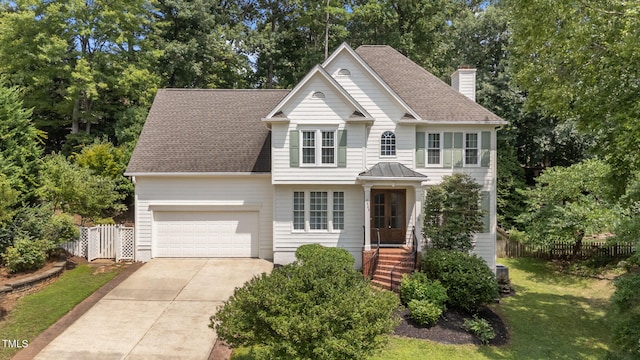7908 Mayapple Pl, Raleigh, NC 27613 - view of front of home featuring driveway, a chimney, an attached garage, and a shingled roof