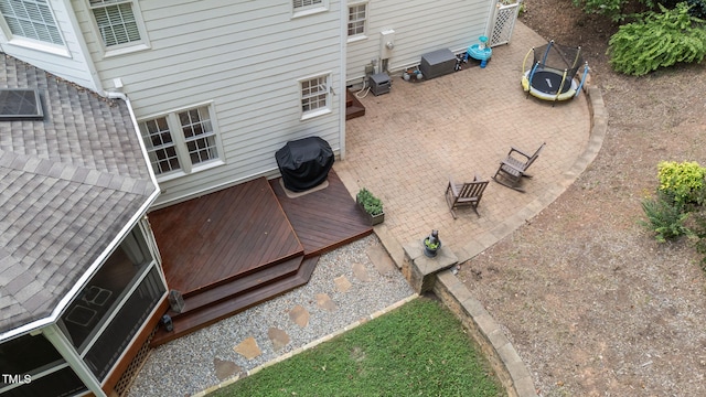 7908 Mayapple Pl, Raleigh, NC 27613 - wooden deck featuring a trampoline, area for grilling, and a patio
