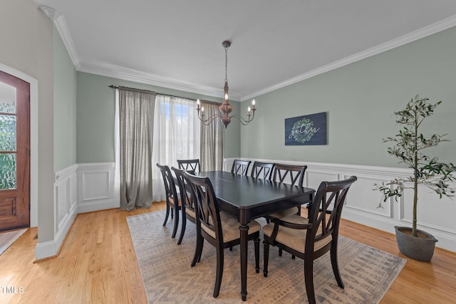 7908 Mayapple Pl, Raleigh, NC 27613 - dining area featuring ornamental molding, light wood-style floors, a chandelier, and wainscoting
