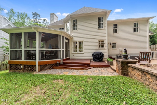 7908 Mayapple Pl, Raleigh, NC 27613 - rear view of house with a sunroom, a chimney, a yard, a wooden deck, and roof with shingles