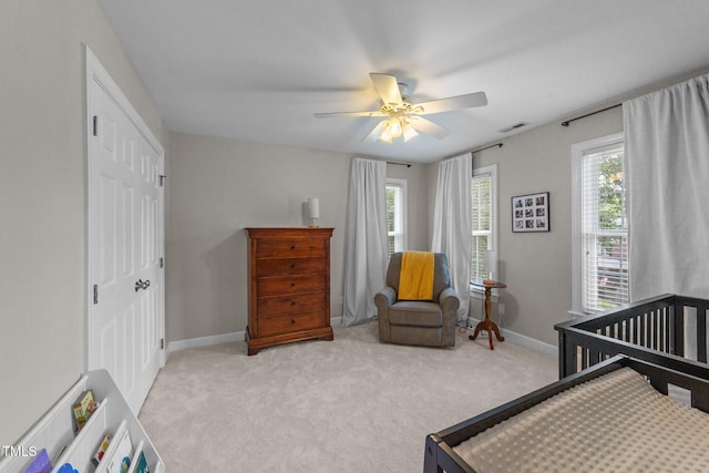 7908 Mayapple Pl, Raleigh, NC 27613 - bedroom with light carpet, ceiling fan, a closet, and a nursery area