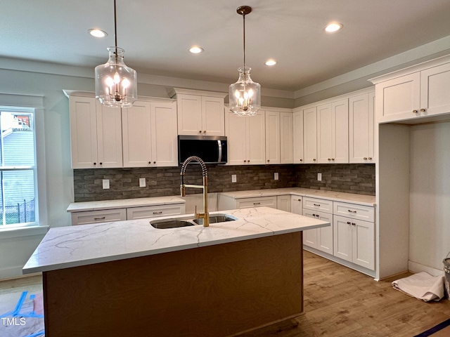 163 Noramac Ct, Selma, NC 27576 - kitchen featuring stainless steel microwave, light wood-type flooring, a chandelier, white cabinets, and recessed lighting