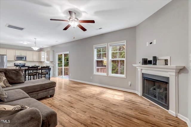 205 Willow Ridge Dr, Louisburg, NC 27549 - living room with light wood-style flooring, a fireplace, and ceiling fan