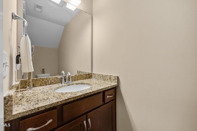 8713 Halsey Ln, Wake Forest, NC 27587 - bathroom featuring vanity and lofted ceiling