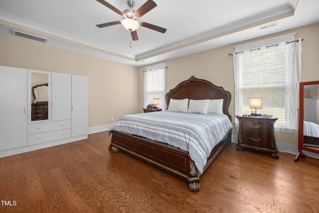 8713 Halsey Ln, Wake Forest, NC 27587 - bedroom with a raised ceiling, wood finished floors, and a ceiling fan