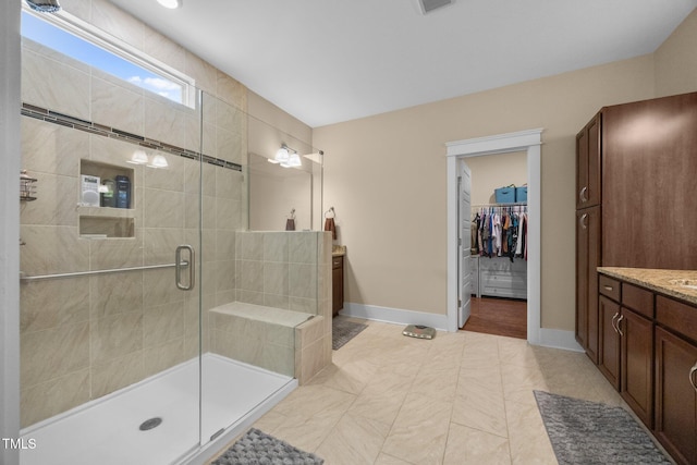 8713 Halsey Ln, Wake Forest, NC 27587 - full bath with vanity, a stall shower, and a spacious closet