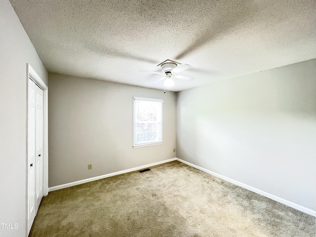 2206 Alpine Rd, Durham, NC 27707 - unfurnished bedroom featuring carpet, a closet, a textured ceiling, and ceiling fan