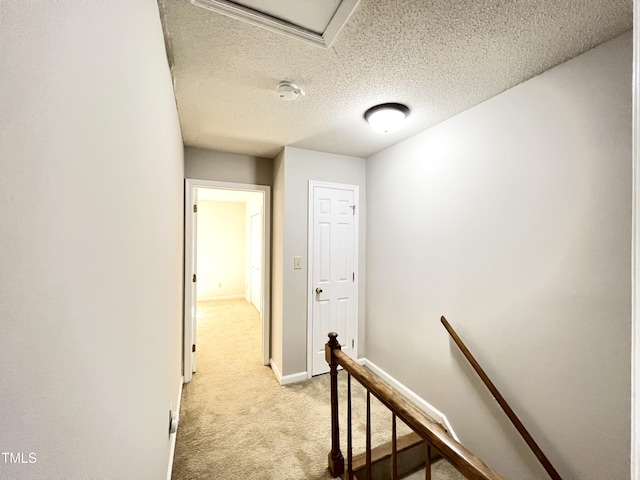 2206 Alpine Rd, Durham, NC 27707 - hallway featuring an upstairs landing, light colored carpet, and a textured ceiling