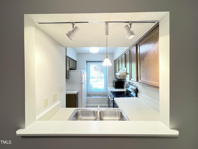 2206 Alpine Rd, Durham, NC 27707 - kitchen featuring electric range, freestanding refrigerator, track lighting, under cabinet range hood, and light countertops