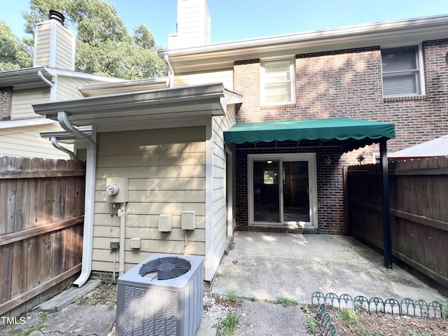 2206 Alpine Rd, Durham, NC 27707 - property entrance featuring brick siding, a chimney, and a patio