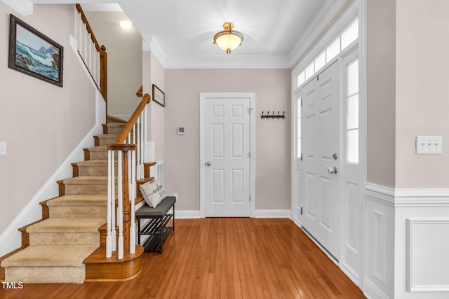 2506 Happy Ln, Raleigh, NC 27614 - entrance foyer with stairway, wood finished floors, and crown molding