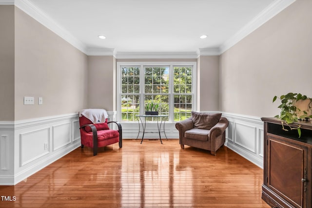 2506 Happy Ln, Raleigh, NC 27614 - sitting room featuring light wood finished floors, wainscoting, a decorative wall, crown molding, and recessed lighting