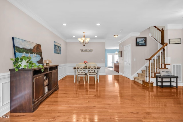 2506 Happy Ln, Raleigh, NC 27614 - dining area featuring a chandelier, stairs, ornamental molding, a decorative wall, and recessed lighting