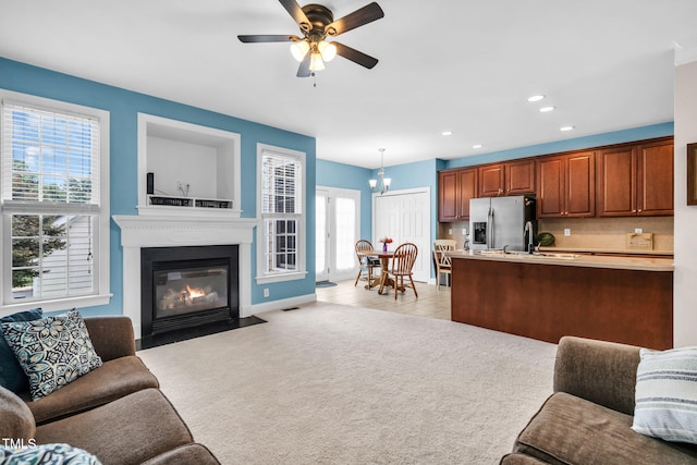 2506 Happy Ln, Raleigh, NC 27614 - living area with recessed lighting, light carpet, ceiling fan, and a fireplace with flush hearth