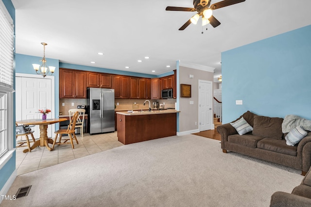 2506 Happy Ln, Raleigh, NC 27614 - living room with light colored carpet, a ceiling fan, a chandelier, recessed lighting, and stairs