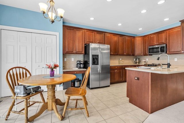 2506 Happy Ln, Raleigh, NC 27614 - kitchen with appliances with stainless steel finishes, light countertops, backsplash, recessed lighting, and hanging light fixtures