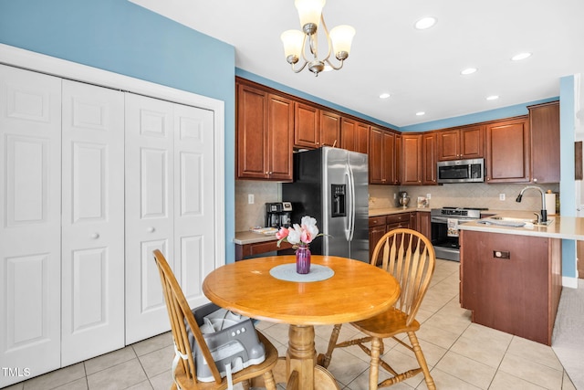 2506 Happy Ln, Raleigh, NC 27614 - kitchen with appliances with stainless steel finishes, light tile patterned flooring, tasteful backsplash, light countertops, and a chandelier