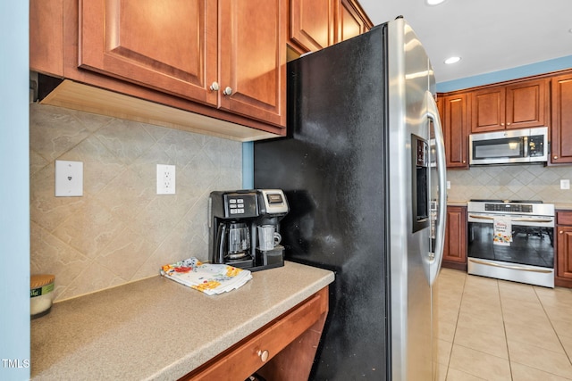 2506 Happy Ln, Raleigh, NC 27614 - kitchen featuring stainless steel appliances, tasteful backsplash, brown cabinets, light countertops, and light tile patterned floors