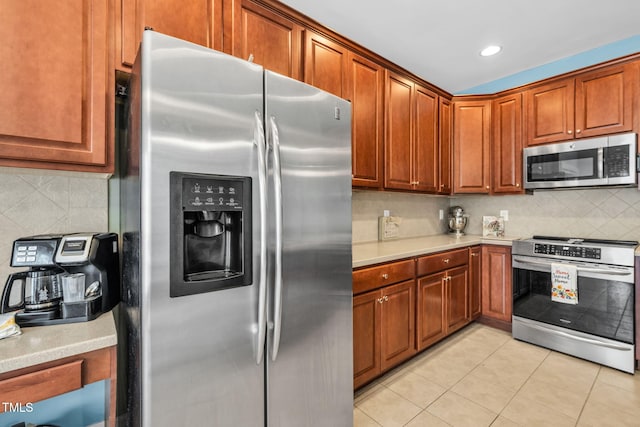2506 Happy Ln, Raleigh, NC 27614 - kitchen with stainless steel appliances, light countertops, backsplash, light tile patterned floors, and recessed lighting
