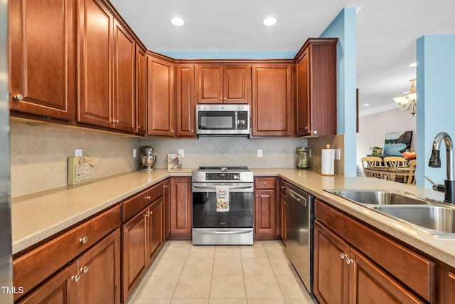 2506 Happy Ln, Raleigh, NC 27614 - kitchen with appliances with stainless steel finishes, backsplash, light countertops, light tile patterned floors, and recessed lighting