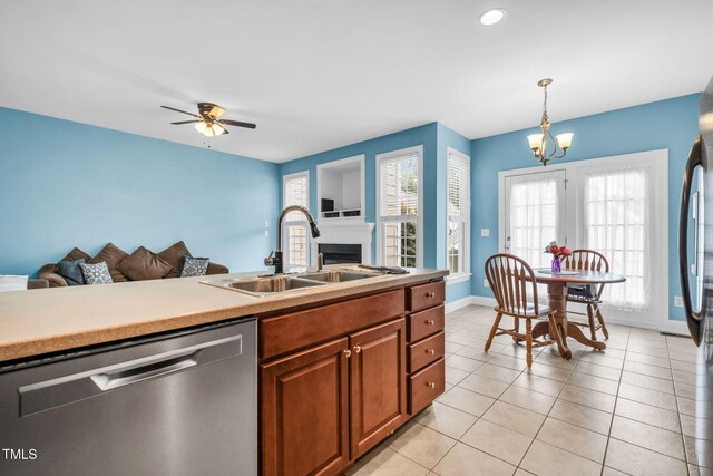 2506 Happy Ln, Raleigh, NC 27614 - kitchen featuring stainless steel dishwasher, open floor plan, a fireplace, and brown cabinetry