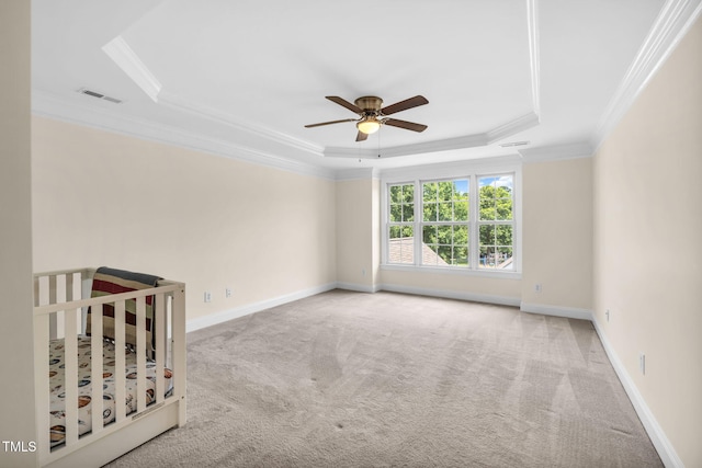 2506 Happy Ln, Raleigh, NC 27614 - unfurnished bedroom featuring a tray ceiling, carpet flooring, crown molding, and a ceiling fan