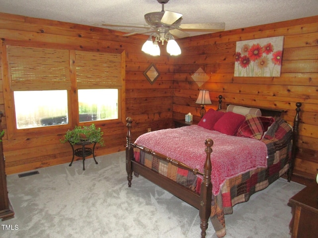1159 Flemingtown Rd, Henderson, NC 27537 - bedroom featuring carpet floors, wooden walls, a textured ceiling, and a ceiling fan