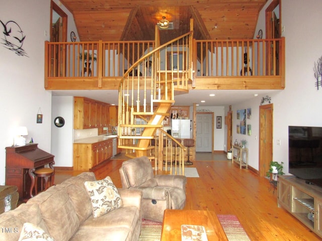 1159 Flemingtown Rd, Henderson, NC 27537 - living room featuring a high ceiling, stairway, and wood finished floors