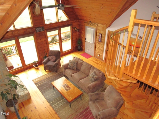 1159 Flemingtown Rd, Henderson, NC 27537 - living area featuring ceiling fan, wooden ceiling, wood finished floors, wooden walls, and high vaulted ceiling