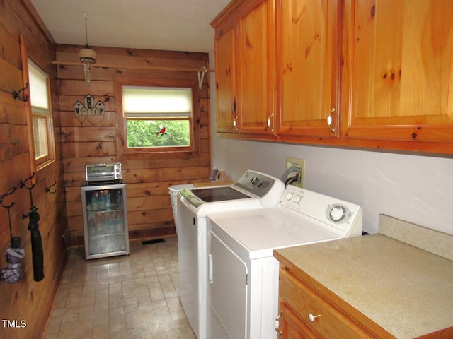 1159 Flemingtown Rd, Henderson, NC 27537 - laundry room with independent washer and dryer, wood walls, cabinet space, and wine cooler