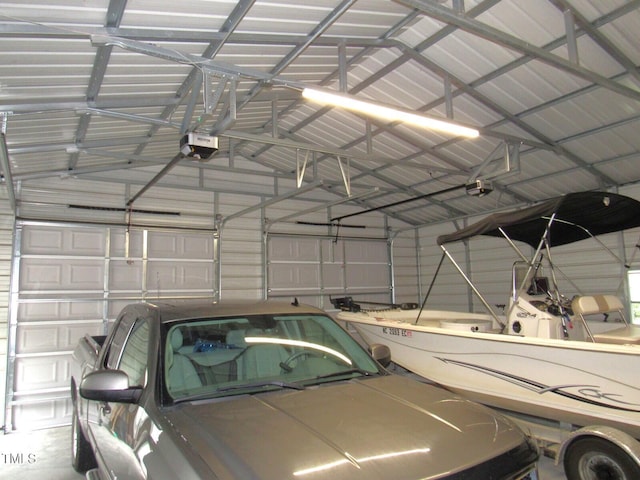 1159 Flemingtown Rd, Henderson, NC 27537 - garage featuring a garage door opener and metal wall