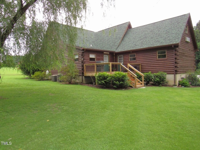 1159 Flemingtown Rd, Henderson, NC 27537 - rear view of house featuring log exterior, a wooden deck, roof with shingles, and a yard