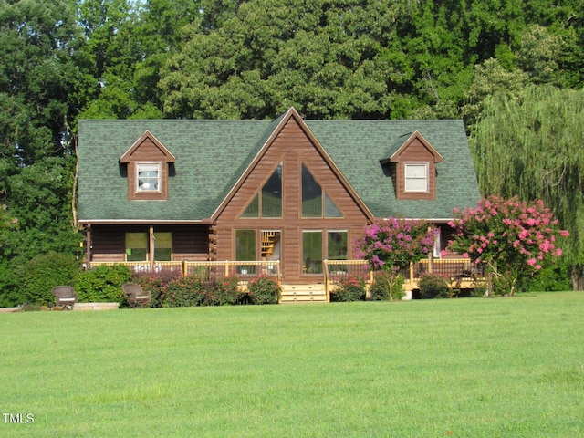 1159 Flemingtown Rd, Henderson, NC 27537 - cabin featuring a front yard, log siding, a shingled roof, and a deck