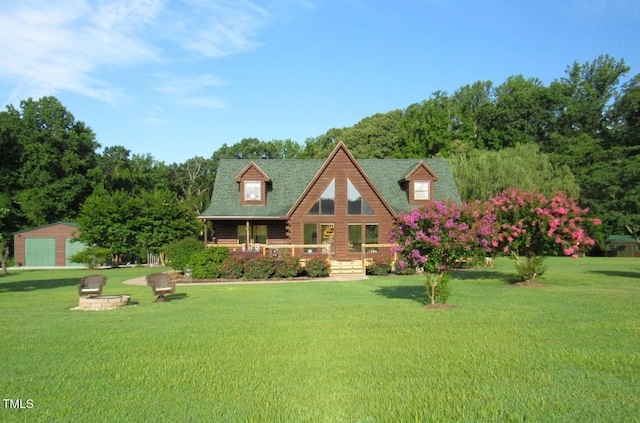 1159 Flemingtown Rd, Henderson, NC 27537 - cabin featuring covered porch, a front yard, an outbuilding, and log siding