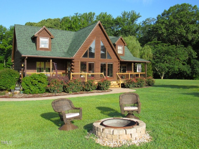 1159 Flemingtown Rd, Henderson, NC 27537 - log home featuring log siding, an outdoor fire pit, a front lawn, a shingled roof, and a deck