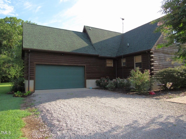 1159 Flemingtown Rd, Henderson, NC 27537 - log-style house featuring an attached garage, driveway, log exterior, and a shingled roof