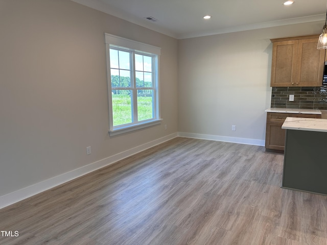 141 Noramac Ct, Selma, NC 27576 - kitchen featuring light wood finished floors, tasteful backsplash, recessed lighting, crown molding, and brown cabinetry
