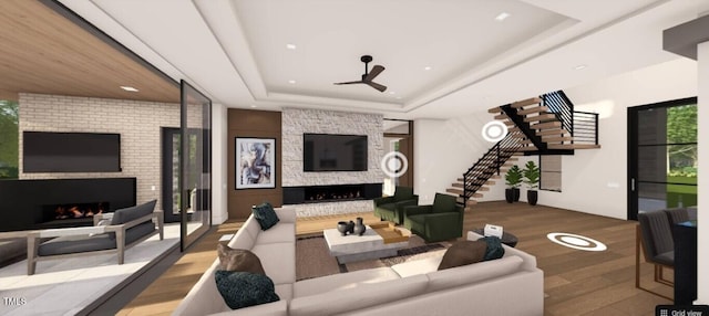 6804 Brixley Cir, Raleigh, NC 27614 - living area featuring a large fireplace, wood finished floors, stairway, a tray ceiling, and recessed lighting