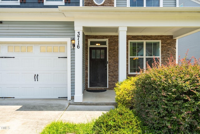 3716 Landshire View Ln, Raleigh, NC 27616 - doorway to property featuring a garage, covered porch, and driveway