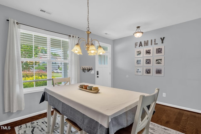 3716 Landshire View Ln, Raleigh, NC 27616 - dining room with a chandelier and dark wood-type flooring