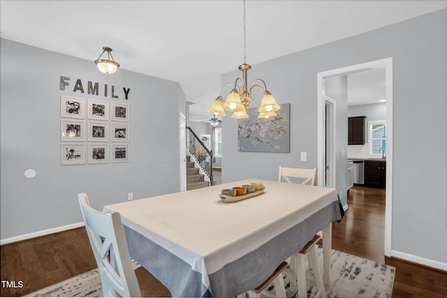 3716 Landshire View Ln, Raleigh, NC 27616 - dining space featuring a chandelier, dark wood-style floors, and stairway