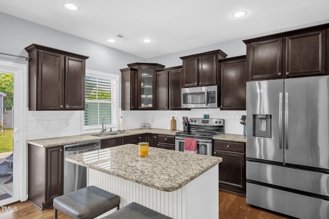 3716 Landshire View Ln, Raleigh, NC 27616 - kitchen with appliances with stainless steel finishes, healthy amount of natural light, dark wood finished floors, a breakfast bar, and recessed lighting