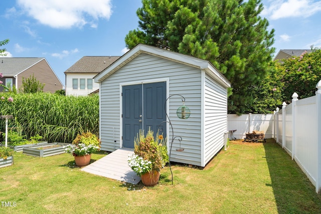 3716 Landshire View Ln, Raleigh, NC 27616 - view of shed featuring a vegetable garden and a fenced backyard