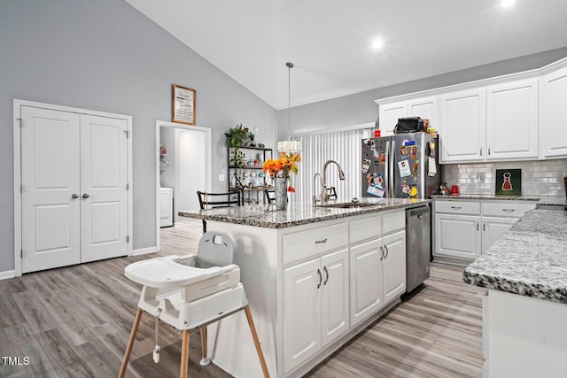 9448 S Beaver Creek Way, Middlesex, NC 27557 - kitchen with stainless steel appliances, decorative backsplash, light wood-type flooring, white cabinets, and high vaulted ceiling
