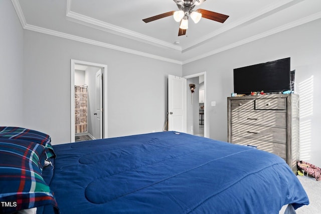 9448 S Beaver Creek Way, Middlesex, NC 27557 - carpeted bedroom featuring a tray ceiling, ornamental molding, a ceiling fan, and connected bathroom