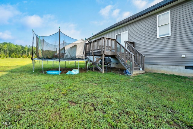 9448 S Beaver Creek Way, Middlesex, NC 27557 - view of grassy yard featuring a trampoline, a wooden deck, and stairs